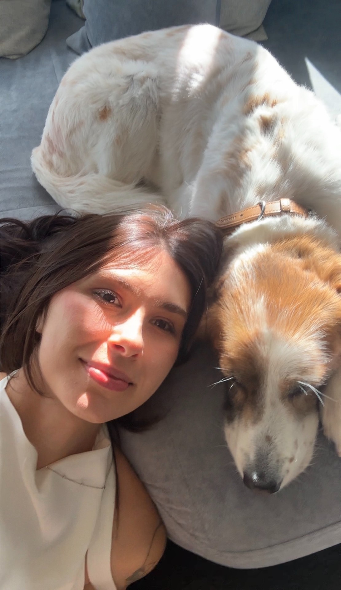 Öykü with a dog in a patch of sunlight