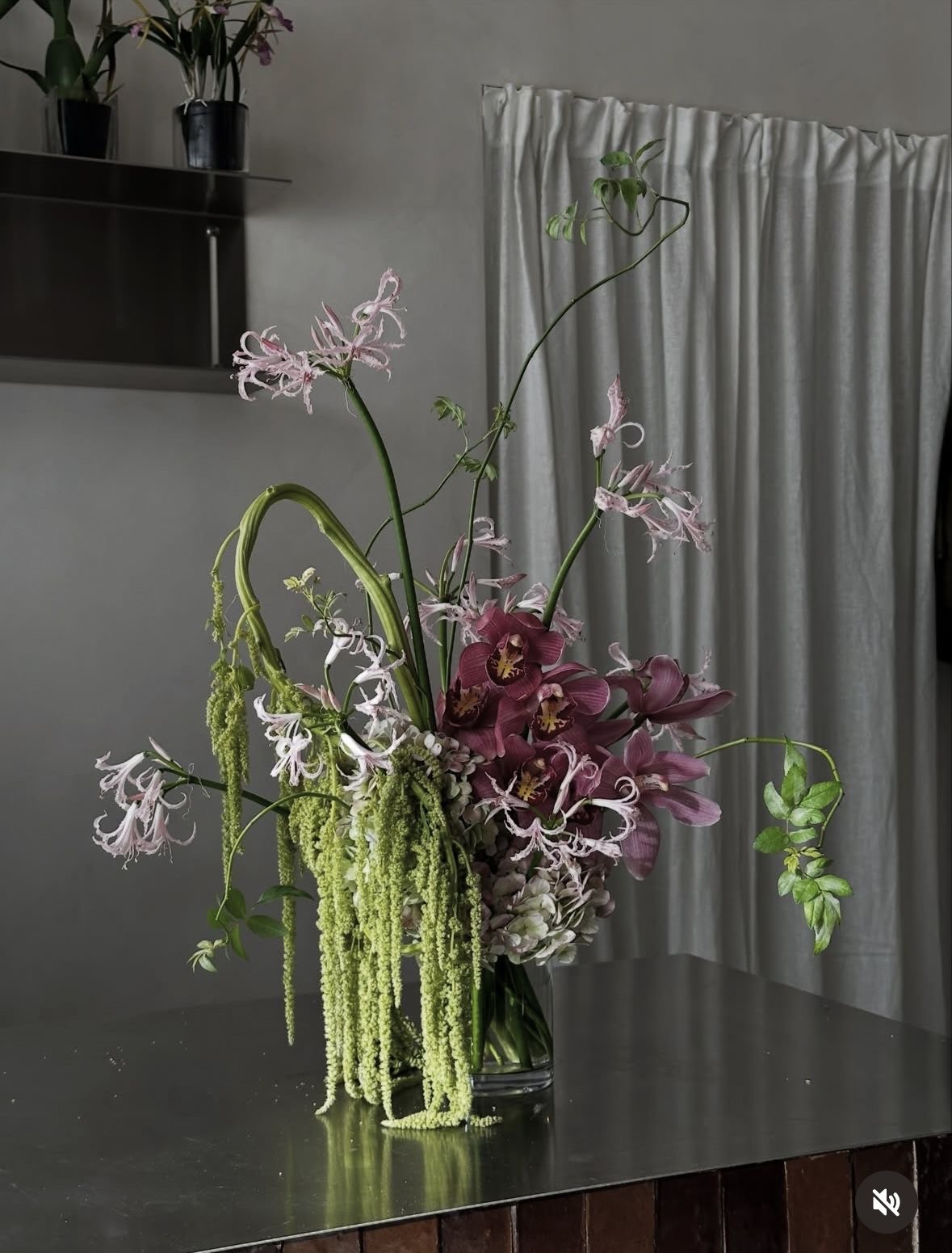 A floral arrangement Öykü made, with orchids, nerines and trailing amaranthus